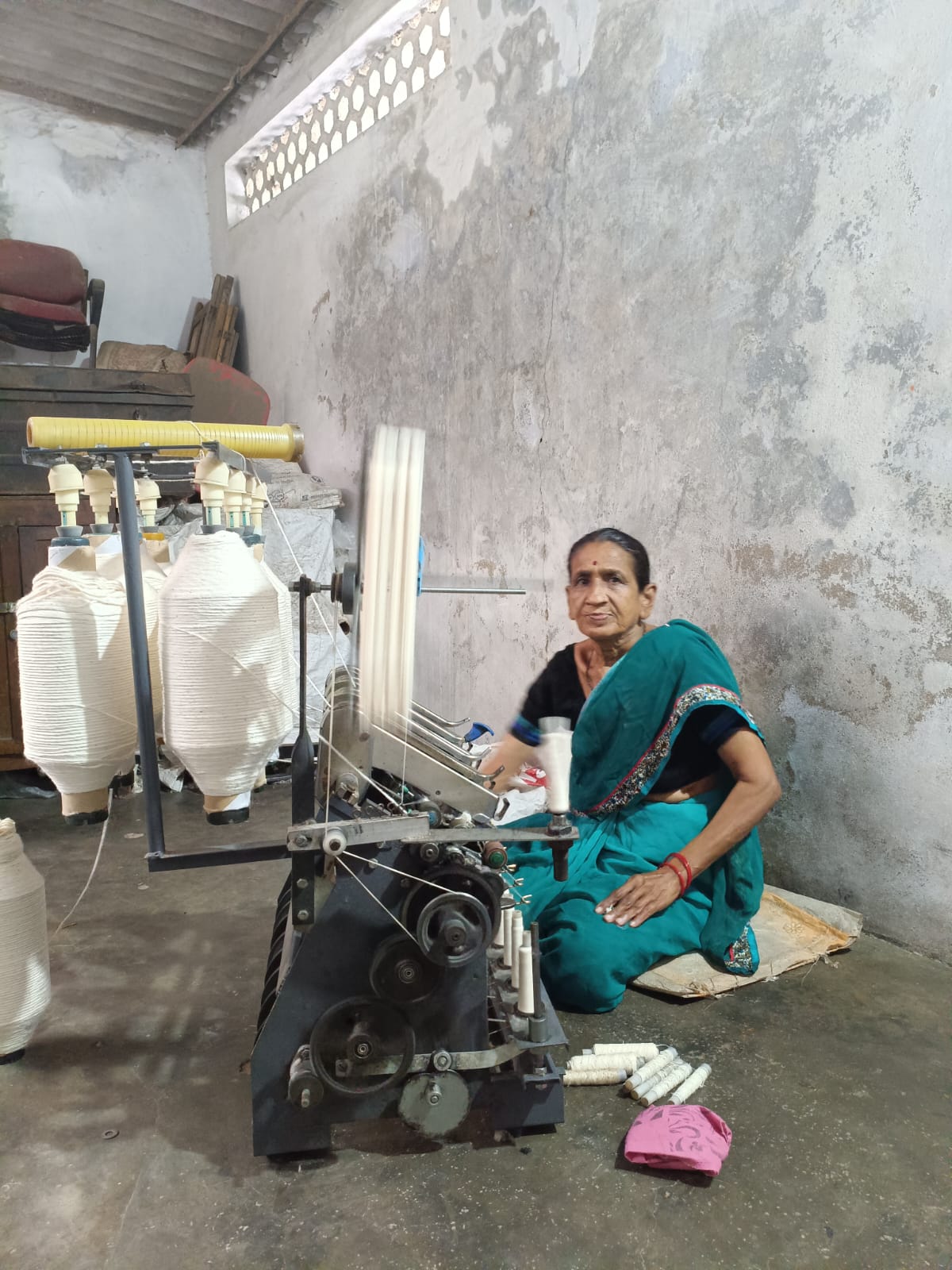 Woman artisan working on spinning machine